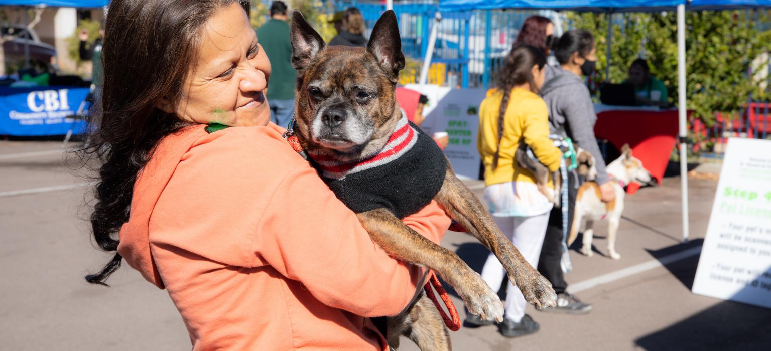 Woman smiling holding her dog