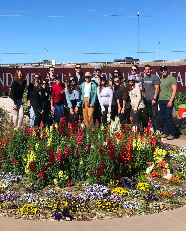 group of people posing outside the urban farm