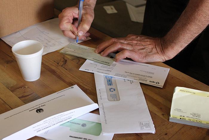 A Vincentian volunteer fills out paperwork to help a family in need.