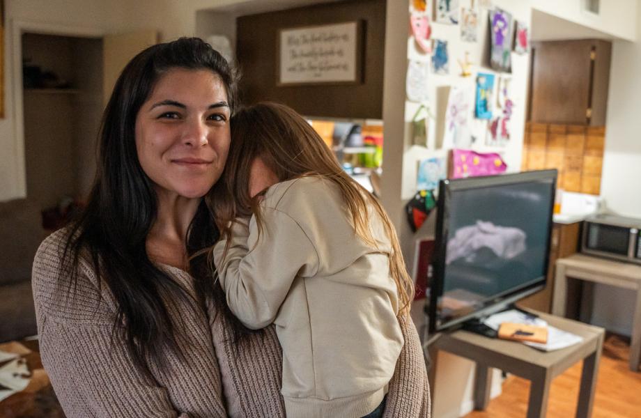 Jesse and her daughter stand in their apartment.