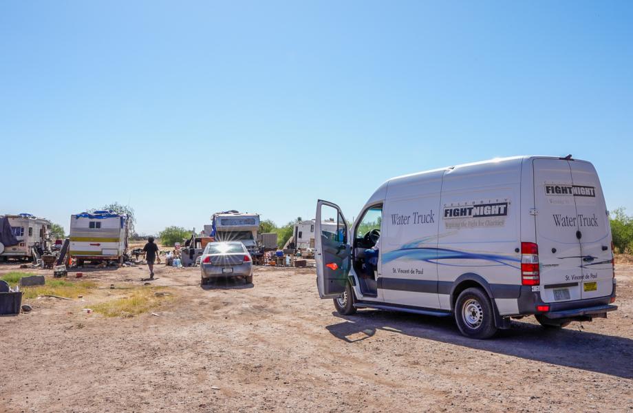 The SVdP Water Truck parks at a family's encampment on the Gila River Indian Reservation.