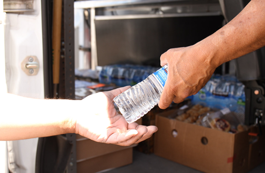 Handing out water to the homeless