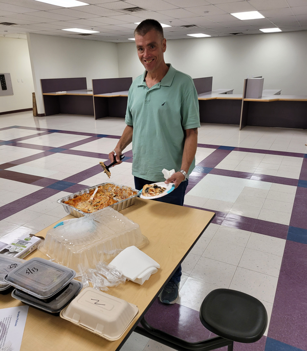 Man scooping food onto a plate