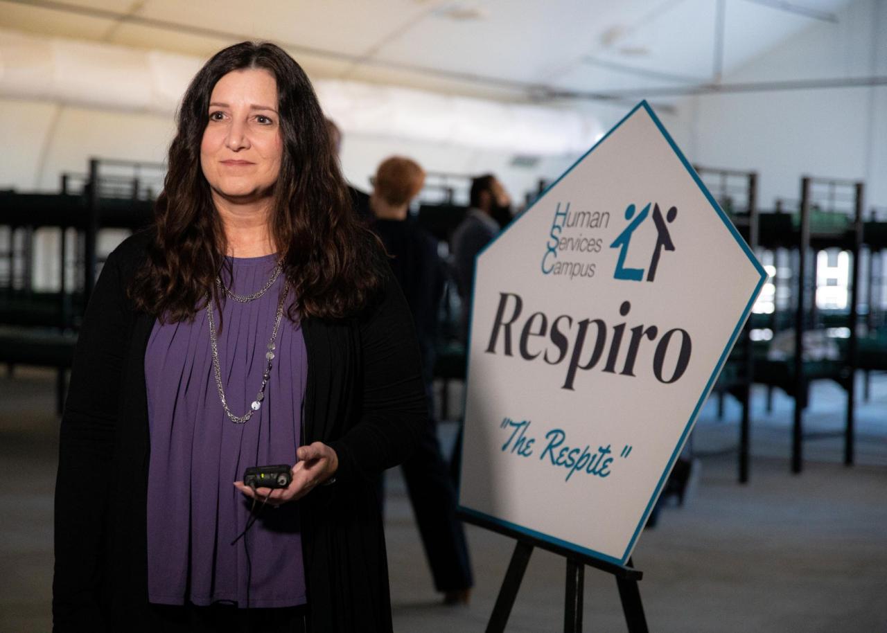 Woman standing in front of a sign