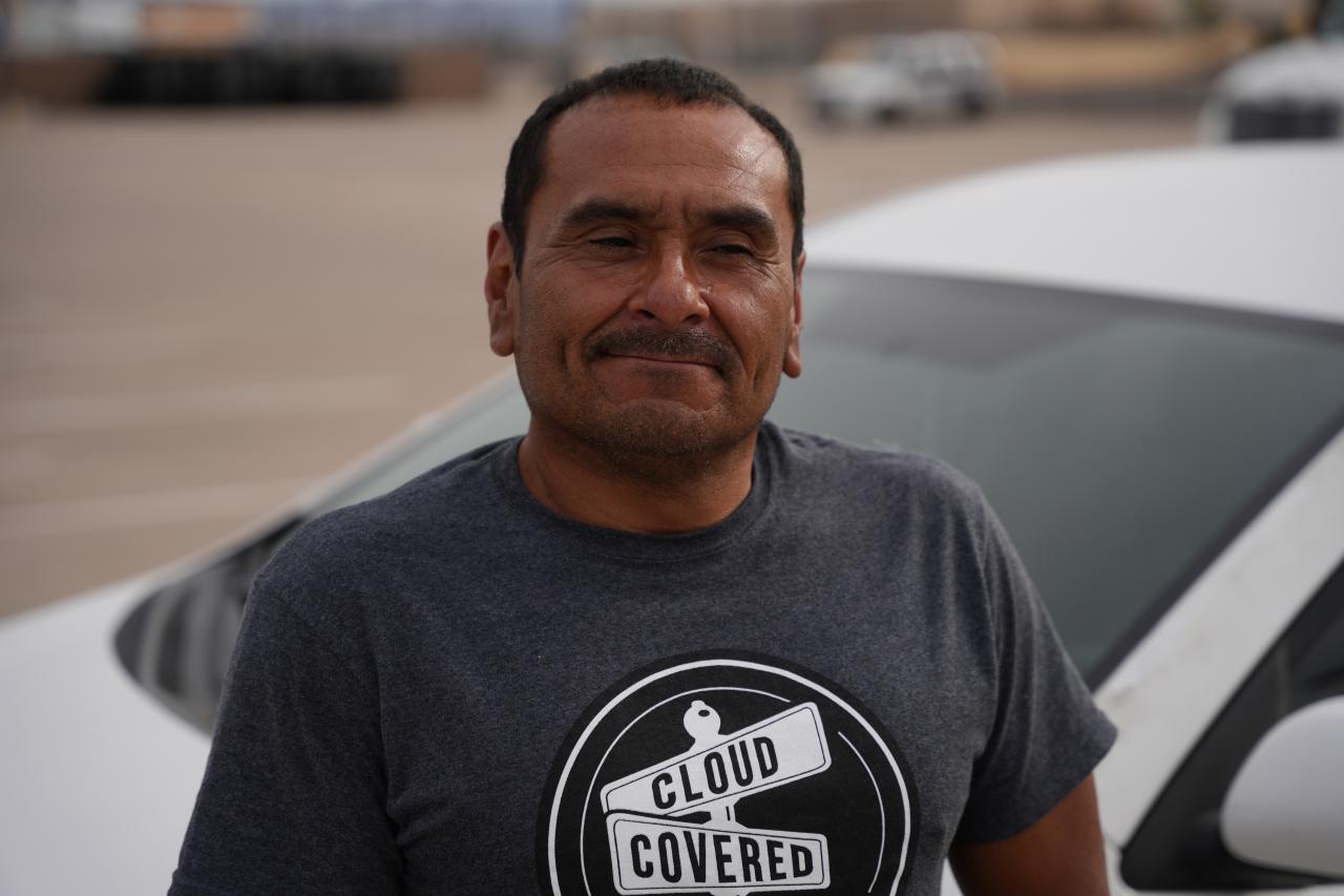 Frank leans against his car in the Washington Street Shelter parking lot.