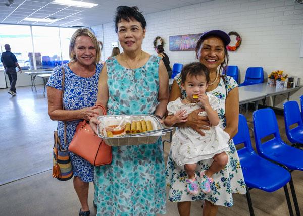 Dana Nguyen (second from left) cooked up fresh spring rolls using veggies from our Mesa farm for our Mesa Dining Room re-opening.