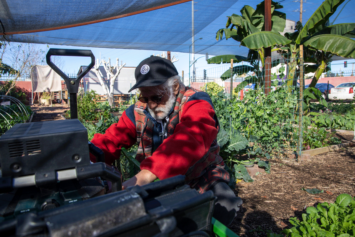 Jim Dilettoso adjusts his sonication speaker in the Mesa Urban Farm.