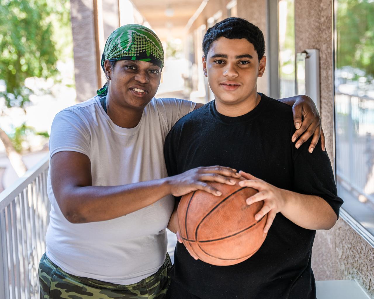 Viola and Jehrique hold his new basketball.