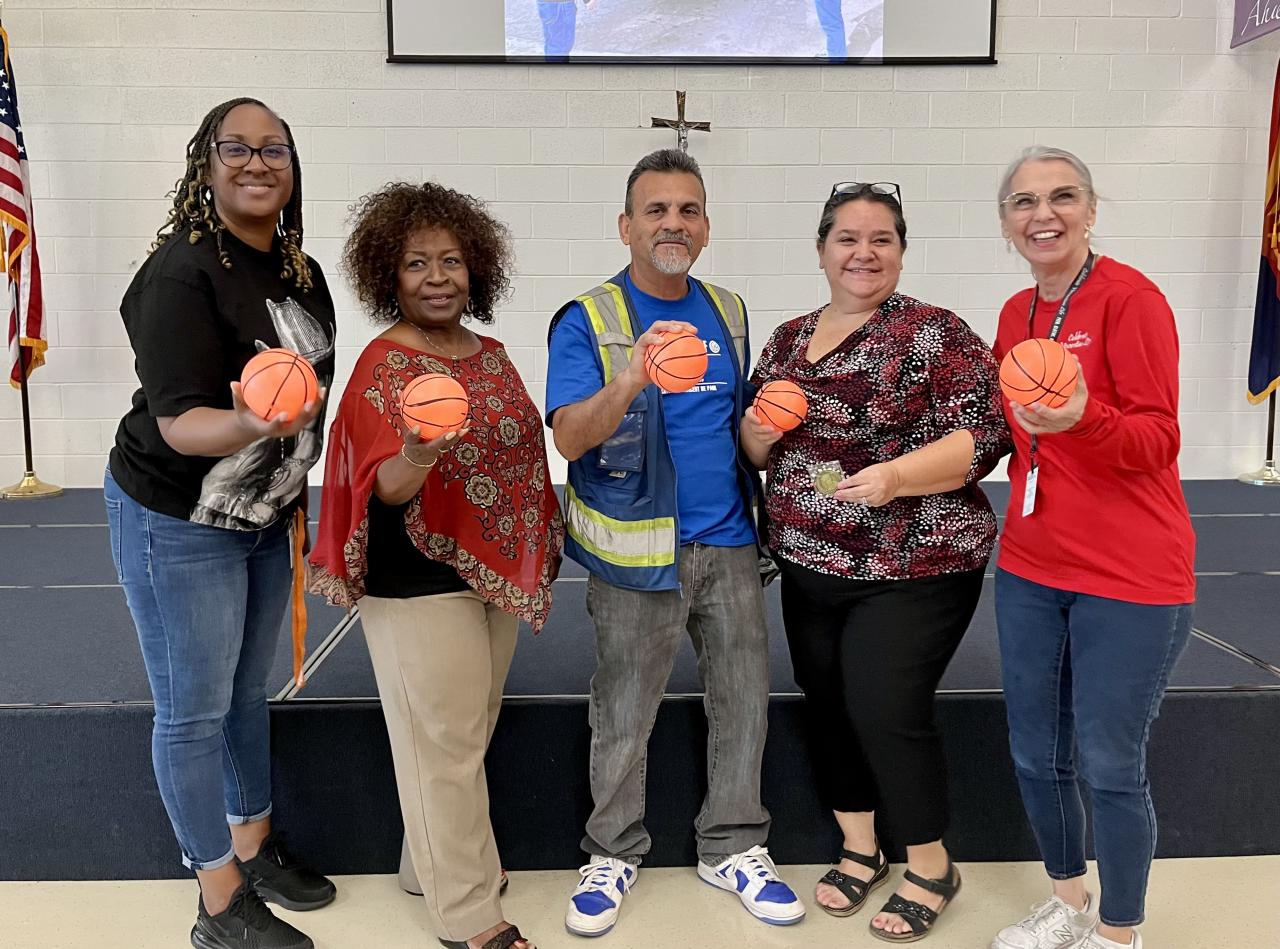 Krashanda, Cherylyn, Frank, Irma, and Cindy line up with little basketballs.