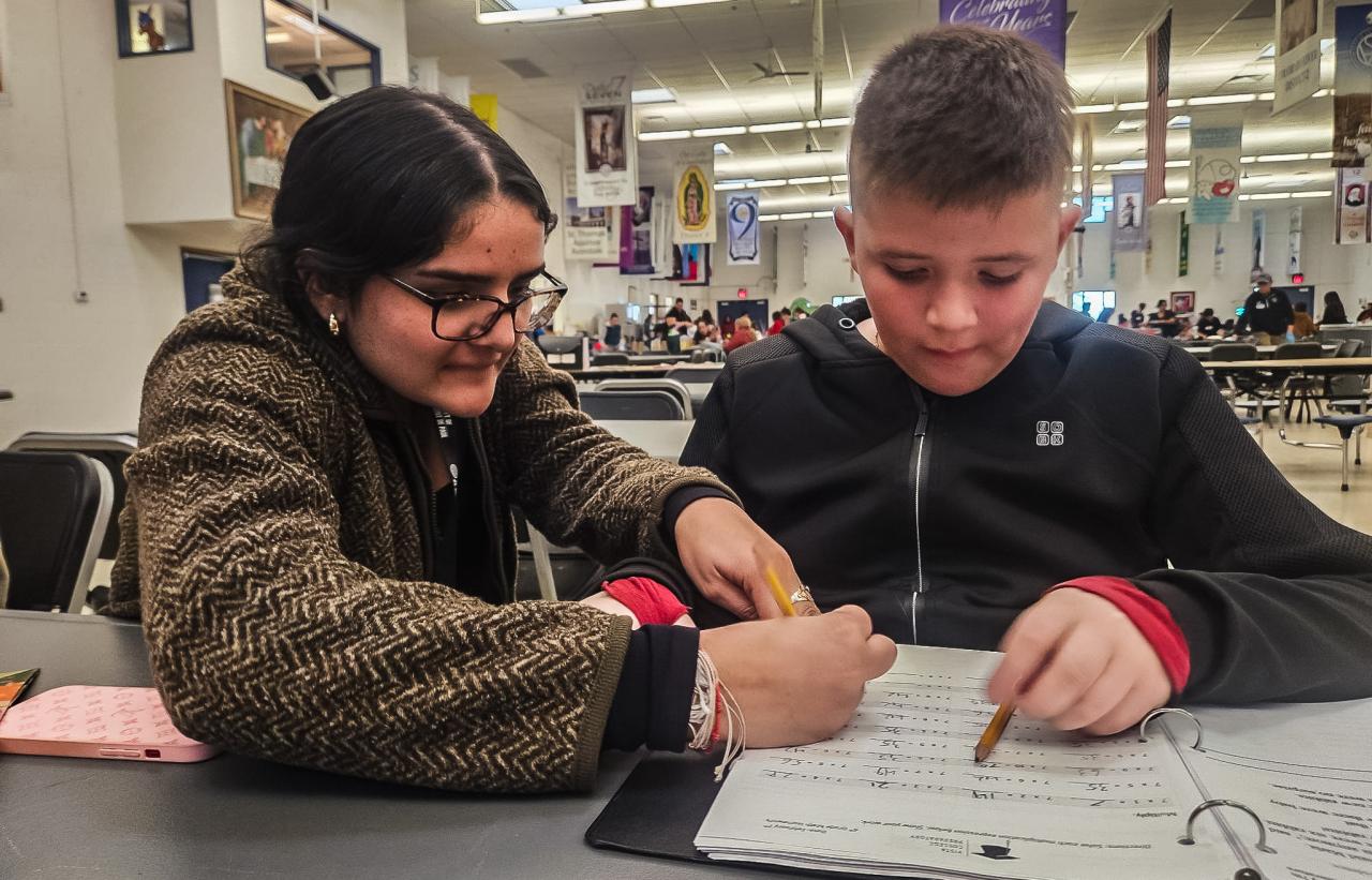 Leilani helps David with his homework in the Dream Center.