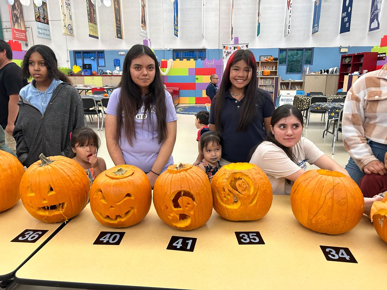 Guests line pumpkins up for judging in the pumpkin carving contest.