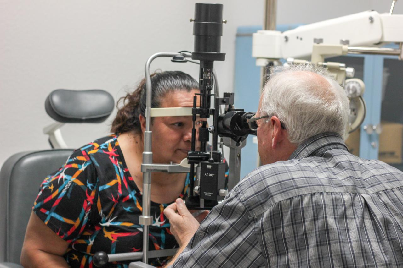 A doctor examines a patient's eye in the SVdP Medical Clinic.