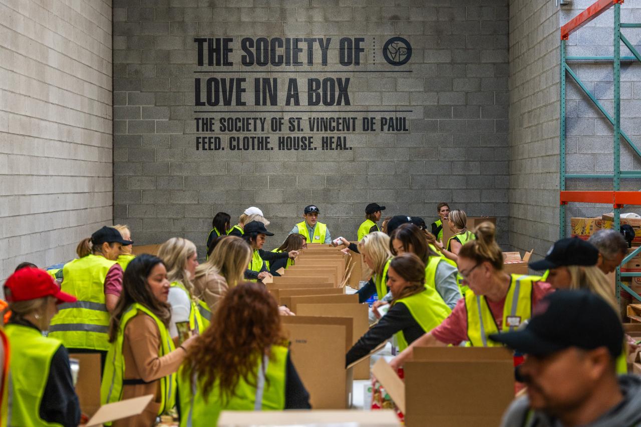 A group of volunteers put together food boxes.