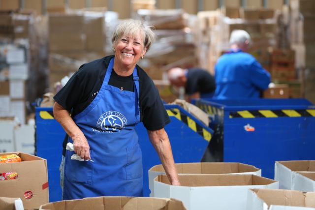 Woman wearing an apron smiling at the camera